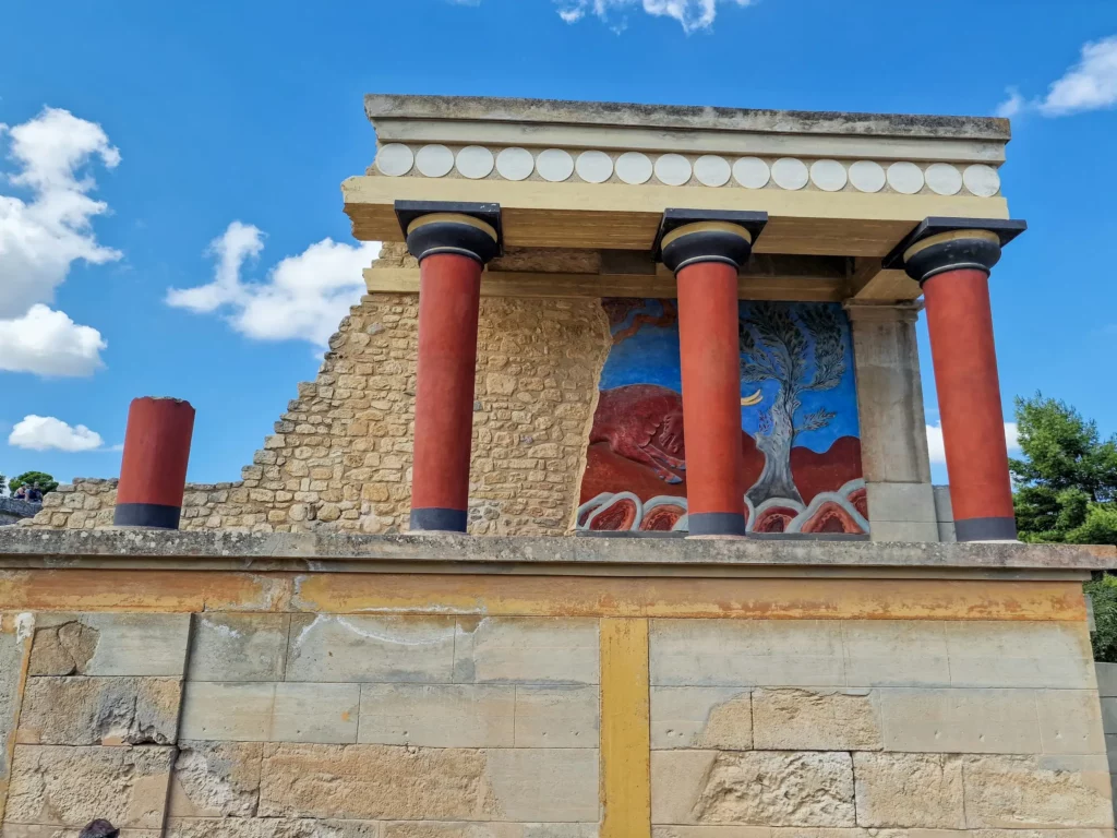 VIP skip-the-line access to Crete Palace of Knossos, guests exploring ancient Minoan frescoes with a private archaeologist guide.